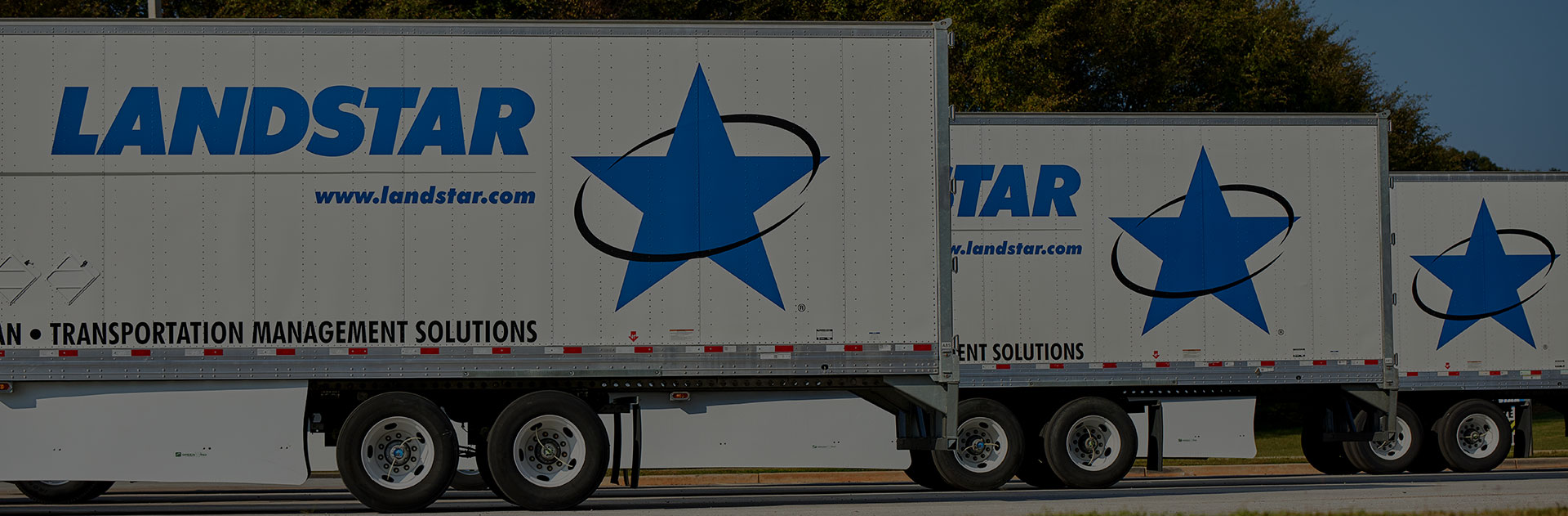 Image of trucks outside of a loading dock.